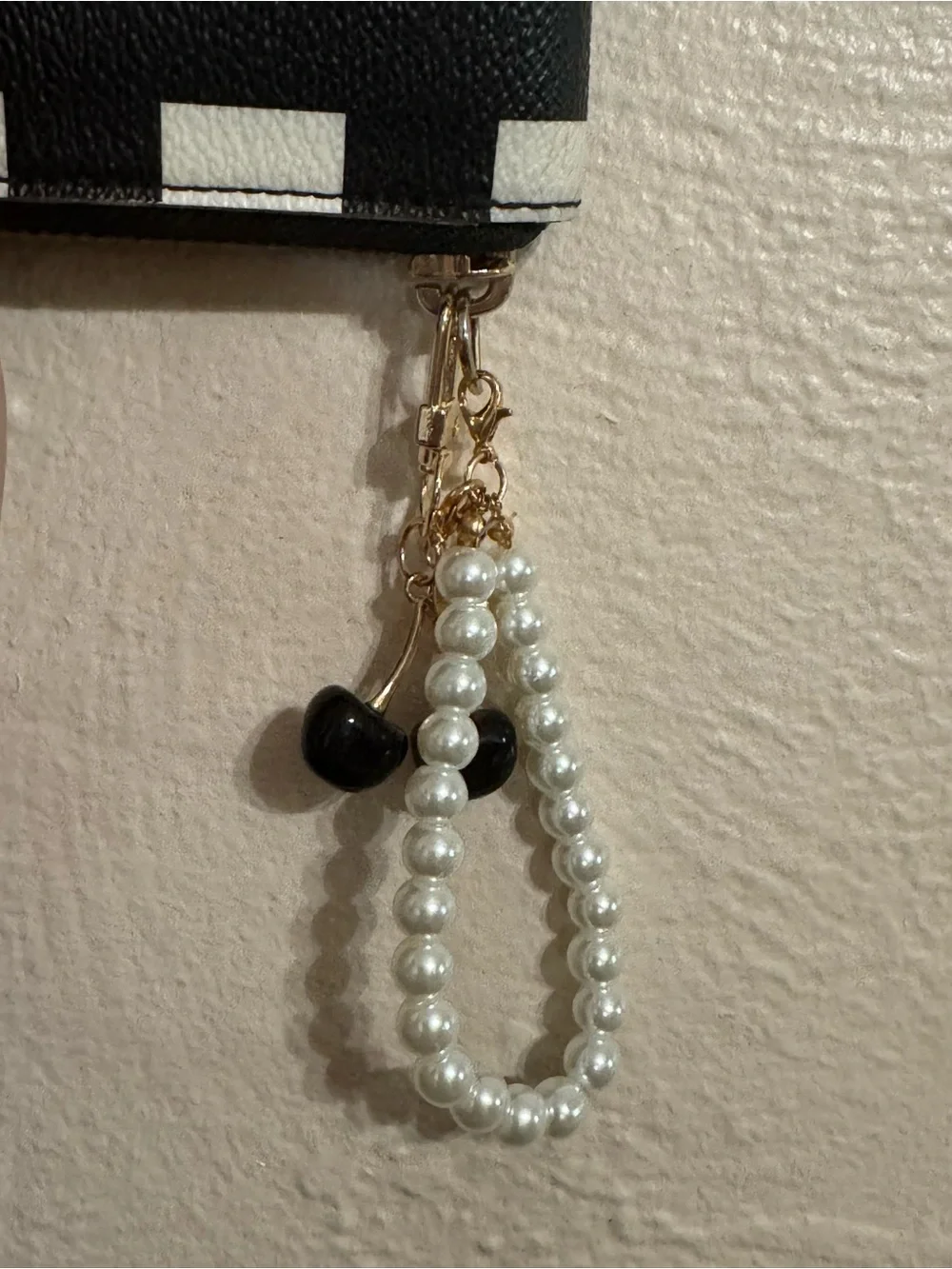 kate spade Black and White Check Zip-Around Wristlet with Pearl Strap